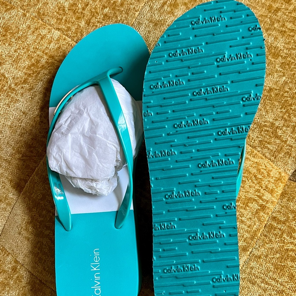 Brand New never worn Calvin Klein Flip Flops- Size 11- Color is Turquoise